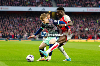 2024-03-10 - Bukayo Saka (7) of Arsenal tussles with Keane Lewis-Potter (23) of Brentford during the English championship Premier League football match between Arsenal and Brentford on 9 March 2024 at the Emirates Stadium in London, England - FOOTBALL - ENGLISH CHAMP - ARSENAL V BRENTFORD - ENGLISH PREMIER LEAGUE - SOCCER