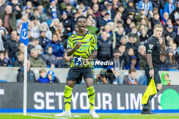 2024-04-06 - Arsenal FC midfielder Bukayo Saka (7) celebrates his goal 0-1 during the English championship Premier League football match between Brighton and Hove Albion and Arsenal on 6 April 2024 at the American Express Stadium in Brighton and Hove, England - FOOTBALL - ENGLISH CHAMP - BRIGHTON V ARSENAL - ENGLISH PREMIER LEAGUE - SOCCER