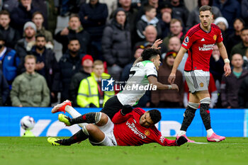 2024-04-07 - Casemiro (18) of Manchester United slides in and tackles Luis Diaz (7) of Liverpool during the English championship Premier League football match between Manchester United and Liverpool on 7 April 2024 at Old Trafford in Manchester, England - FOOTBALL - ENGLISH CHAMP - MANCHESTER UNITED V LIVERPOOL - ENGLISH PREMIER LEAGUE - SOCCER