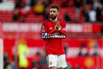 2024-04-07 - Bruno Fernandes (8) of Manchester United thanks fans at full time during the English championship Premier League football match between Manchester United and Liverpool on 7 April 2024 at Old Trafford in Manchester, England - FOOTBALL - ENGLISH CHAMP - MANCHESTER UNITED V LIVERPOOL - ENGLISH PREMIER LEAGUE - SOCCER