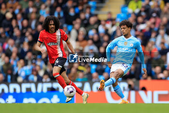 2024-04-13 - Oscar Bobb (52) of Manchester City and Tahith Chong of Luton Town during the English championship Premier League football match between Manchester City and Luton Town on 13 April 2024 at the Etihad Stadium in Manchester, England - FOOTBALL - ENGLISH CHAMP - MANCHESTER CITY V LUTON TOWN - ENGLISH PREMIER LEAGUE - SOCCER