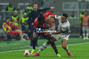 2024-02-15 - Rafael Leao of AC Milan competes for the ball with Guela Doue of Stade Rennais FC during UEFA Europa League 2023/24 Play-Off - 1st  leg football match between AC Milan and Rennes Stade Rennais FC at San Siro Stadium, Milan, Italy on February 15, 2024 - AC MILAN VS RENNAIS FC - UEFA EUROPA LEAGUE - SOCCER