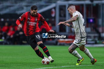 2024-04-11 - Theo Hernandez of AC Milan seen in action with Gianluca Mancini of AS Roma during UEFA Europa League 2023/24 Quarter Finals - 1st  leg football match between AC Milan and AS Roma at San Siro Stadium, Milan, Italy on April 11, 2024 - AC MILAN VS AS ROMA - UEFA EUROPA LEAGUE - SOCCER