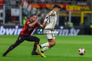 2024-04-11 - Paulo Dybala of AS Roma competes for the ball with Ismael Bennacer of AC Milan during UEFA Europa League 2023/24 Quarter Finals - 1st  leg football match between AC Milan and AS Roma at San Siro Stadium, Milan, Italy on April 11, 2024 - AC MILAN VS AS ROMA - UEFA EUROPA LEAGUE - SOCCER