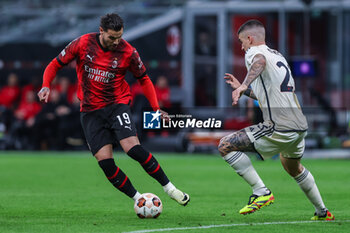 2024-04-11 - Theo Hernandez of AC Milan (L) seen in action with Gianluca Mancini of AS Roma (R) during UEFA Europa League 2023/24 Quarter Finals - 1st  leg football match between AC Milan and AS Roma at San Siro Stadium, Milan, Italy on April 11, 2024 - AC MILAN VS AS ROMA - UEFA EUROPA LEAGUE - SOCCER