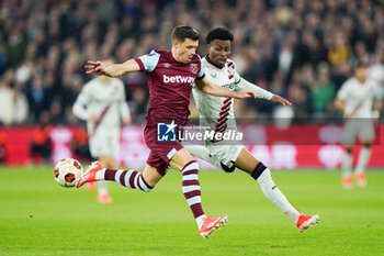 2024-04-18 - Aaron Cresswell of West Ham United and Nathan Tella of Bayer Leverkusen during the UEFA Europa League, Quater-Finals, 2nd Leg football match between West Ham United FC and Bayer 04 Leverkusen on 18 April 2024 at London Stadium in London, England - FOOTBALL - EUROPA LEAGUE - WEST HAM V BAYER LEVERKUSEN - UEFA EUROPA LEAGUE - SOCCER