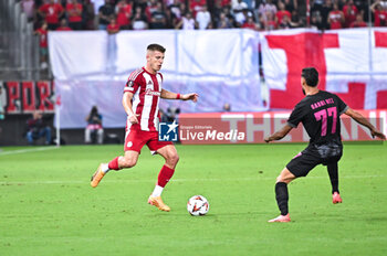 2024-10-03 - 20 Costinha of Olympiacos FC competing with 77 Gabri Martinez of SC Braga during the Europa League, Matchday 2 match between Olympiacos FC and SC Braga at Georgios Karaiskakis Stadium on October 3, 2024, in Piraeus, Greece. - OLYMPIACOS FC VS SC BRAGA - UEFA EUROPA LEAGUE - SOCCER