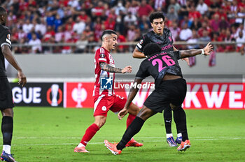 2024-10-03 - 22 Chiquinho of Olympiacos FC competing with 26 Bright Arrey-Mbi of SC Braga during the Europa League, Matchday 2 match between Olympiacos FC and SC Braga at Georgios Karaiskakis Stadium on October 3, 2024, in Piraeus, Greece. - OLYMPIACOS FC VS SC BRAGA - UEFA EUROPA LEAGUE - SOCCER