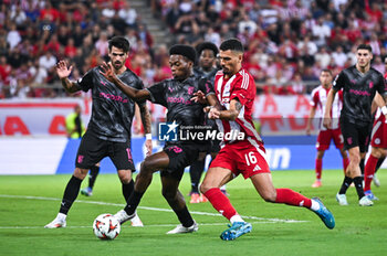 2024-10-03 - 16 David Carmo of Olympiacos FC competing with 29 Jean-Baptiste Gorby of SC Braga during the Europa League, Matchday 2 match between Olympiacos FC and SC Braga at Georgios Karaiskakis Stadium on October 3, 2024, in Piraeus, Greece. - OLYMPIACOS FC VS SC BRAGA - UEFA EUROPA LEAGUE - SOCCER