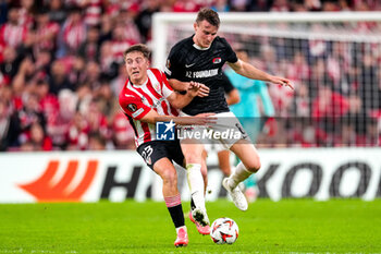 2024-10-03 - Mikel Jaureguizar of Athletic Club and Peer Koopmeiners of AZ Alkmaar during the UEFA Europa League, League Phase, Matchday 2 football match between Athletic Club and AZ Alkmaar on October 3, 2024 at Estadio de San Mamés in Bilbao, Spain - FOOTBALL - EUROPA LEAGUE - ATHLETIC CLUB V AZ ALKMAAR - UEFA EUROPA LEAGUE - SOCCER