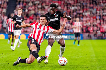 2024-10-03 - Daniel Vivian of Athletic Club battles for possession with Ernest Poku of AZ Alkmaar during the UEFA Europa League, League Phase, Matchday 2 football match between Athletic Club and AZ Alkmaar on October 3, 2024 at Estadio de San Mamés in Bilbao, Spain - FOOTBALL - EUROPA LEAGUE - ATHLETIC CLUB V AZ ALKMAAR - UEFA EUROPA LEAGUE - SOCCER