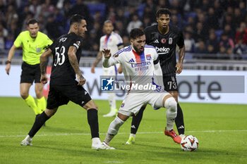 2024-10-24 - Rayan Cherki of Lyon between Emirhan Topcu and Cher Ndour of Besiktas during the UEFA Europa League, League phase, matchday 3 football match between Olympique Lyonnais (Lyon) and Besiktas JK on 24 October 2024 at Groupama stadium in Decines-Charpieu near Lyon, France - FOOTBALL - EUROPA LEAGUE - LYON V BESIKTAS - UEFA EUROPA LEAGUE - SOCCER