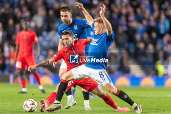 2024-10-24 - Connor Barron of Rangers FC and Alexandru Baluța of FC Steaua Bucharest during the UEFA Europa League, League phase, Matchday 3 football match between Rangers and Steaua Bucharest on 24 October 2024 at Ibrox in Glasgow, Scotland - FOOTBALL - EUROPA LEAGUE - RANGERS V FCSB - UEFA EUROPA LEAGUE - SOCCER