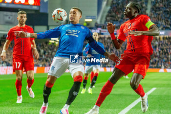 2024-10-24 - James Tavernier of Rangers and Joyskim Dawa of Steaua Bucharest during the UEFA Europa League, League phase, Matchday 3 football match between Rangers and Steaua Bucharest on 24 October 2024 at Ibrox in Glasgow, Scotland - FOOTBALL - EUROPA LEAGUE - RANGERS V FCSB - UEFA EUROPA LEAGUE - SOCCER