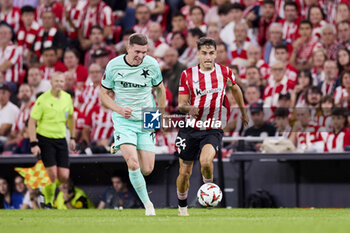 2024-10-24 - Lukas Provod of SK Slavia Praha and Benat Prados of Athletic Club during the UEFA Europa League, League phase, Matchday 3 football match between Athletic Club and SK Slavia Praha on October 24, 2024 at San Mames in Bilbao, Spain - FOOTBALL - EUROPA LEAGUE - ATHLETIC CLUB V SLAVIA PRAHA - UEFA EUROPA LEAGUE - SOCCER