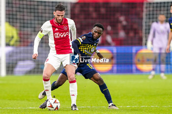 2024-11-07 - Branco van den Boomen of AFC Ajax battles for possession with Issouf Sissokho of Maccabi Tel Aviv during the UEFA Europa League, League Phase, MD4 football match between AFC Ajax and Maccabi Tel Aviv on November 7, 2024 at Johan Cruijff ArenA in Amsterdam, Netherlands - FOOTBALL - EUROPA LEAGUE - AJAX V MACCABI TEL AVIV - UEFA EUROPA LEAGUE - SOCCER