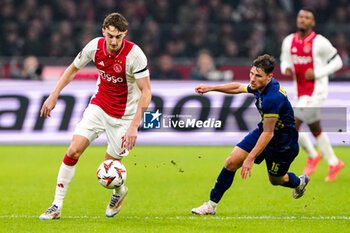 2024-11-07 - Youri Baas of AFC Ajax battles for possession with Gavriel Kanichowsky of Maccabi Tel Aviv during the UEFA Europa League, League Phase, MD4 football match between AFC Ajax and Maccabi Tel Aviv on November 7, 2024 at Johan Cruijff ArenA in Amsterdam, Netherlands - FOOTBALL - EUROPA LEAGUE - AJAX V MACCABI TEL AVIV - UEFA EUROPA LEAGUE - SOCCER