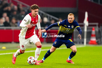 2024-11-07 - Mika Godts of AFC Ajax battles for possession with Ido Shahar of Maccabi Tel Aviv during the UEFA Europa League, League Phase, MD4 football match between AFC Ajax and Maccabi Tel Aviv on November 7, 2024 at Johan Cruijff ArenA in Amsterdam, Netherlands - FOOTBALL - EUROPA LEAGUE - AJAX V MACCABI TEL AVIV - UEFA EUROPA LEAGUE - SOCCER