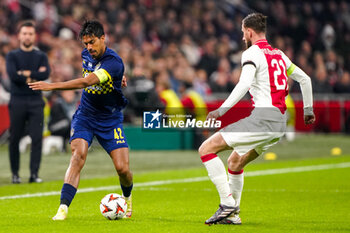 2024-11-07 - Dor Peretz of Maccabi Tel Aviv battles for possession with Branco van den Boomen of AFC Ajax during the UEFA Europa League, League Phase, MD4 football match between AFC Ajax and Maccabi Tel Aviv on November 7, 2024 at Johan Cruijff ArenA in Amsterdam, Netherlands - FOOTBALL - EUROPA LEAGUE - AJAX V MACCABI TEL AVIV - UEFA EUROPA LEAGUE - SOCCER