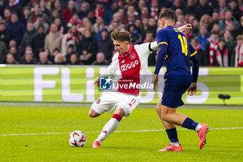 2024-11-07 - Raz Shlomo of Maccabi Tel Aviv and Mika Godts of AFC Ajax during the UEFA Europa League, League Phase, MD4 football match between AFC Ajax and Maccabi Tel Aviv on November 7, 2024 at Johan Cruijff ArenA in Amsterdam, Netherlands - FOOTBALL - EUROPA LEAGUE - AJAX V MACCABI TEL AVIV - UEFA EUROPA LEAGUE - SOCCER