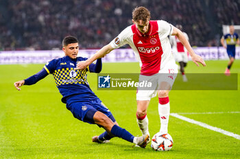 2024-11-07 - Elad Madmon of Maccabi Tel Aviv battles for possession with Youri Baas of AFC Ajax during the UEFA Europa League, League Phase, MD4 football match between AFC Ajax and Maccabi Tel Aviv on November 7, 2024 at Johan Cruijff ArenA in Amsterdam, Netherlands - FOOTBALL - EUROPA LEAGUE - AJAX V MACCABI TEL AVIV - UEFA EUROPA LEAGUE - SOCCER