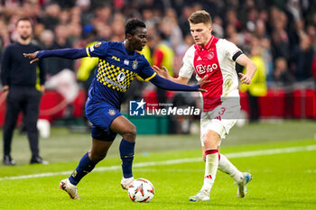 2024-11-07 - Henry Addo of Maccabi Tel Aviv battles for possession with Anton Gaaei of AFC Ajax during the UEFA Europa League, League Phase, MD4 football match between AFC Ajax and Maccabi Tel Aviv on November 7, 2024 at Johan Cruijff ArenA in Amsterdam, Netherlands - FOOTBALL - EUROPA LEAGUE - AJAX V MACCABI TEL AVIV - UEFA EUROPA LEAGUE - SOCCER