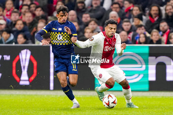 2024-11-07 - Weslley Patati of Maccabi Tel Aviv battles for possession with Owen Wijndal of AFC Ajax during the UEFA Europa League, League Phase, MD4 football match between AFC Ajax and Maccabi Tel Aviv on November 7, 2024 at Johan Cruijff ArenA in Amsterdam, Netherlands - FOOTBALL - EUROPA LEAGUE - AJAX V MACCABI TEL AVIV - UEFA EUROPA LEAGUE - SOCCER