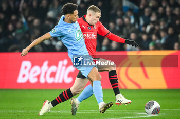 2024-02-29 - Tommy IVA of Le Puy and Adrien TRUFFERT of Rennes during the French Cup, Quarter-Finals football match between Le Puy Foot 43 Auvergne and Stade Rennais (Rennes) on February 29, 2024 at Geoffroy Guichard stadium in Saint-Etienne, France - FOOTBALL - FRENCH CUP - LE PUY V RENNES - FRENCH CUP - SOCCER