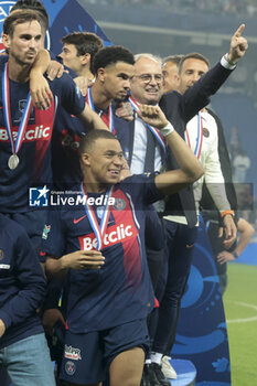 2024-05-25 - Kylian Mbappe of PSG, above Fabian Ruiz Pena, Warren Zaire-Emery, PSG manager Luis Campos during the podium ceremony following the French Cup Final football match between Olympique Lyonnais (OL, Lyon) and Paris Saint-Germain (PSG) on May 25, 2024 at Stade Pierre Mauroy, Decathlon Arena in Villeneuve-d'Ascq near Lille, France - FOOTBALL - FRENCH CUP - FINAL - LYON V PARIS SG - FRENCH CUP - SOCCER