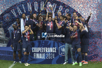 2024-05-25 - Vitinha of PSG holding the trophy, Kylian Mbappe and teammates celebrate during the podium ceremony following the French Cup Final football match between Olympique Lyonnais (OL, Lyon) and Paris Saint-Germain (PSG) on May 25, 2024 at Stade Pierre Mauroy, Decathlon Arena in Villeneuve-d'Ascq near Lille, France - FOOTBALL - FRENCH CUP - FINAL - LYON V PARIS SG - FRENCH CUP - SOCCER