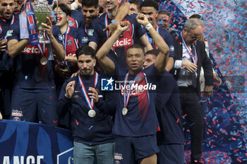 2024-05-25 - Kylian Mbappe of PSG and teammates celebrate during the podium ceremony following the French Cup Final football match between Olympique Lyonnais (OL, Lyon) and Paris Saint-Germain (PSG) on May 25, 2024 at Stade Pierre Mauroy, Decathlon Arena in Villeneuve-d'Ascq near Lille, France - FOOTBALL - FRENCH CUP - FINAL - LYON V PARIS SG - FRENCH CUP - SOCCER