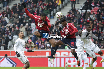 2024-01-14 - Jonathan David of Lille (R) scores his goal when Alexsandro Ribeiro of Lille jumps in front of him during the French championship Ligue 1 football match between Losc Lille and FC Lorient on January 14, 2024 at Decathlon Arena Stade Pierre Mauroy in Villeneuve-d'Ascq, France - FOOTBALL - FRENCH CHAMP - LILLE V LORIENT - FRENCH LIGUE 1 - SOCCER