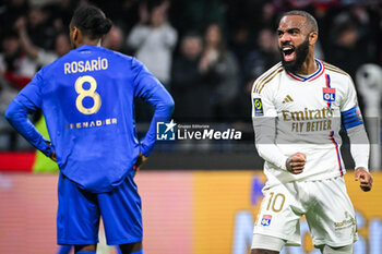 2024-02-16 - Alexandre LACAZETTE of Lyon celebrates the victory and Cristian Pablo PAULINO ROSARIO of Nice looks dejected during the French championship Ligue 1 football match between Olympique Lyonnais (Lyon) and OGC Nice on February 16, 2024 at Groupama stadium in Decines-Charpieu near Lyon, France - FOOTBALL - FRENCH CHAMP - LYON V NICE - FRENCH LIGUE 1 - SOCCER