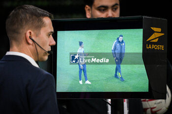 2024-02-16 - Referee Clement TURPIN consults the Video Assistant Referee (VAR) during the French championship Ligue 1 football match between Olympique Lyonnais (Lyon) and OGC Nice on February 16, 2024 at Groupama stadium in Decines-Charpieu near Lyon, France - FOOTBALL - FRENCH CHAMP - LYON V NICE - FRENCH LIGUE 1 - SOCCER