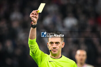 2024-02-16 - Referee Clement TURPIN gives a yellow card during the French championship Ligue 1 football match between Olympique Lyonnais (Lyon) and OGC Nice on February 16, 2024 at Groupama stadium in Decines-Charpieu near Lyon, France - FOOTBALL - FRENCH CHAMP - LYON V NICE - FRENCH LIGUE 1 - SOCCER
