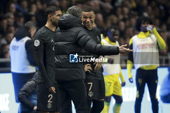 2024-02-17 - Kylian Mbappe of PSG jokes with PSG coach Luis Enrique (left) during the French championship Ligue 1 football match between FC Nantes and Paris Saint-Germain on February 17, 2024 at La Beaujoire - Louis Fonteneau stadium in Nantes, France - FOOTBALL - FRENCH CHAMP - NANTES V PARIS SG - FRENCH LIGUE 1 - SOCCER