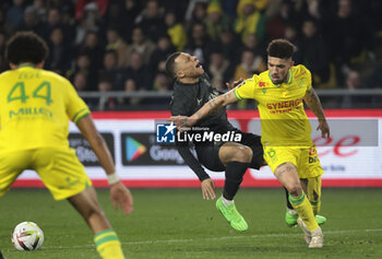 2024-02-17 - Douglas Augusto of Nantes commits a fault on Kylian Mbappe of PSG leading to a penalty during the French championship Ligue 1 football match between FC Nantes and Paris Saint-Germain on February 17, 2024 at La Beaujoire - Louis Fonteneau stadium in Nantes, France - FOOTBALL - FRENCH CHAMP - NANTES V PARIS SG - FRENCH LIGUE 1 - SOCCER