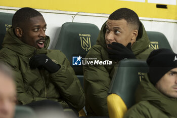 2024-02-17 - Ousmane Dembele and Kylian Mbappe of PSG on the bench during the French championship Ligue 1 football match between FC Nantes and Paris Saint-Germain on February 17, 2024 at La Beaujoire - Louis Fonteneau stadium in Nantes, France - FOOTBALL - FRENCH CHAMP - NANTES V PARIS SG - FRENCH LIGUE 1 - SOCCER