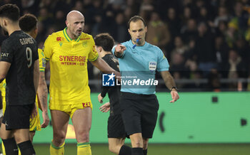 2024-02-17 - Nicolas Pallois of Nantes protests against the penalty awarded by Referee Jerome Brisard during the French championship Ligue 1 football match between FC Nantes and Paris Saint-Germain on February 17, 2024 at La Beaujoire - Louis Fonteneau stadium in Nantes, France - FOOTBALL - FRENCH CHAMP - NANTES V PARIS SG - FRENCH LIGUE 1 - SOCCER