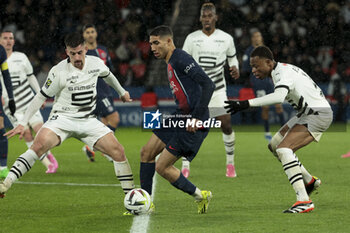 2024-02-25 - Achraf Hakimi of PSG between Baptiste Santamaria, Jeanuel Belocian of Rennes during the French championship Ligue 1 football match between Paris Saint-Germain and Stade Rennais (Rennes) on February 25, 2024 at Parc des Princes stadium in Paris, France - FOOTBALL - FRENCH CHAMP - PARIS SG V RENNES - FRENCH LIGUE 1 - SOCCER