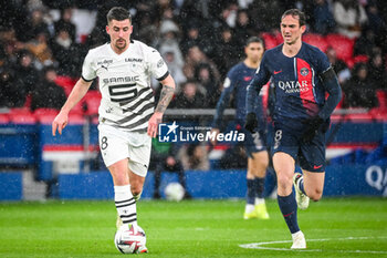 2024-02-25 - Baptiste SANTAMARIA of Rennes and Fabian RUIZ of PSG during the French championship Ligue 1 football match between Paris Saint-Germain and Stade Rennais (Rennes) on February 25, 2024 at Parc des Princes stadium in Paris, France - FOOTBALL - FRENCH CHAMP - PARIS SG V RENNES - FRENCH LIGUE 1 - SOCCER