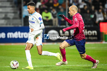 2024-03-02 - Azzedine OUNAHI of Marseille and Johan GASTIEN of Clermont during the French championship Ligue 1 football match between Clermont Foor 63 and Olympique de Marseille on March 2, 2024 at Gabriel Montpied stadium in Clermont-Ferrand, France - FOOTBALL - FRENCH CHAMP - CLERMONT V MARSEILLE - FRENCH LIGUE 1 - SOCCER