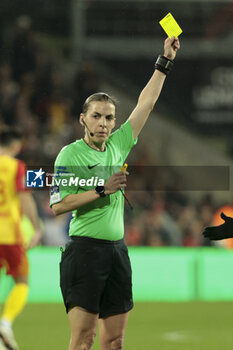 2024-03-09 - Referee Stephanie Frappart gives a yellow card during the French championship Ligue 1 football match between RC Lens and Stade Brestois on March 9, 2024 at Bollaert Delelis stadium in Lens, France - FOOTBALL - FRENCH CHAMP - LENS V BREST - FRENCH LIGUE 1 - SOCCER