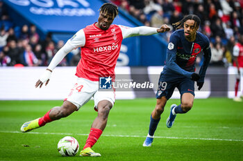 2024-03-10 - Emmanuel AGBADOU of Reims and Bradley BARCOLA of PSG during the French championship Ligue 1 football match between Paris Saint-Germain and Stade de Reims on March 10, 2024 at Parc des Princes stadium in Paris, France - FOOTBALL - FRENCH CHAMP - PARIS SG V REIMS - FRENCH LIGUE 1 - SOCCER