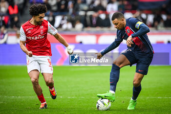 2024-03-10 - Reda KHADRA of Reims and Kylian MBAPPE of PSG during the French championship Ligue 1 football match between Paris Saint-Germain and Stade de Reims on March 10, 2024 at Parc des Princes stadium in Paris, France - FOOTBALL - FRENCH CHAMP - PARIS SG V REIMS - FRENCH LIGUE 1 - SOCCER