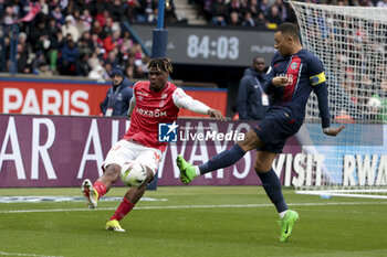2024-03-10 - Emmanuel Agbadou of Reims, Kylian Mbappe of PSG during the French championship Ligue 1 football match between Paris Saint-Germain and Stade de Reims on March 10, 2024 at Parc des Princes stadium in Paris, France - FOOTBALL - FRENCH CHAMP - PARIS SG V REIMS - FRENCH LIGUE 1 - SOCCER