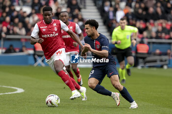 2024-03-10 - Warren Zaire-Emery of PSG, left Marshall Munetsi of Reims during the French championship Ligue 1 football match between Paris Saint-Germain and Stade de Reims on March 10, 2024 at Parc des Princes stadium in Paris, France - FOOTBALL - FRENCH CHAMP - PARIS SG V REIMS - FRENCH LIGUE 1 - SOCCER