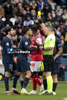 2024-03-10 - Achraf Hakimi of PSG receives a yellow card from referee Willy Delajod during the French championship Ligue 1 football match between Paris Saint-Germain and Stade de Reims on March 10, 2024 at Parc des Princes stadium in Paris, France - FOOTBALL - FRENCH CHAMP - PARIS SG V REIMS - FRENCH LIGUE 1 - SOCCER