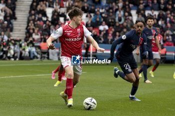 2024-03-10 - Thomas Foket of Reims, Bradley Barcola of PSG during the French championship Ligue 1 football match between Paris Saint-Germain and Stade de Reims on March 10, 2024 at Parc des Princes stadium in Paris, France - FOOTBALL - FRENCH CHAMP - PARIS SG V REIMS - FRENCH LIGUE 1 - SOCCER