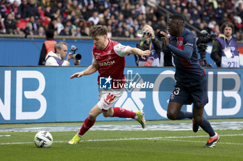2024-03-10 - Thomas Foket of Reims, Randal Kolo Muani of PSG during the French championship Ligue 1 football match between Paris Saint-Germain and Stade de Reims on March 10, 2024 at Parc des Princes stadium in Paris, France - FOOTBALL - FRENCH CHAMP - PARIS SG V REIMS - FRENCH LIGUE 1 - SOCCER